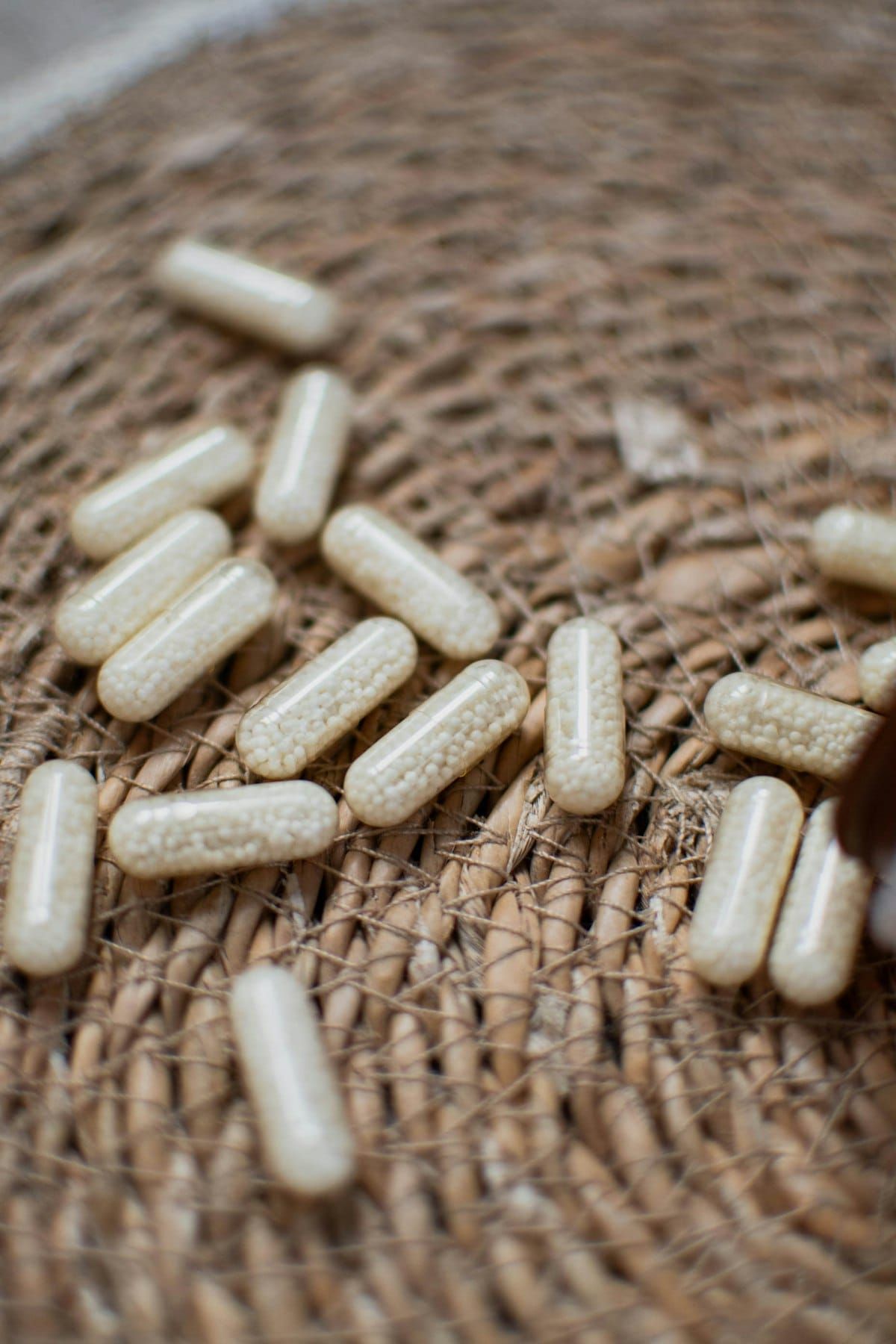 Supplement capsules on natural texture — Uninfluenced Labs
