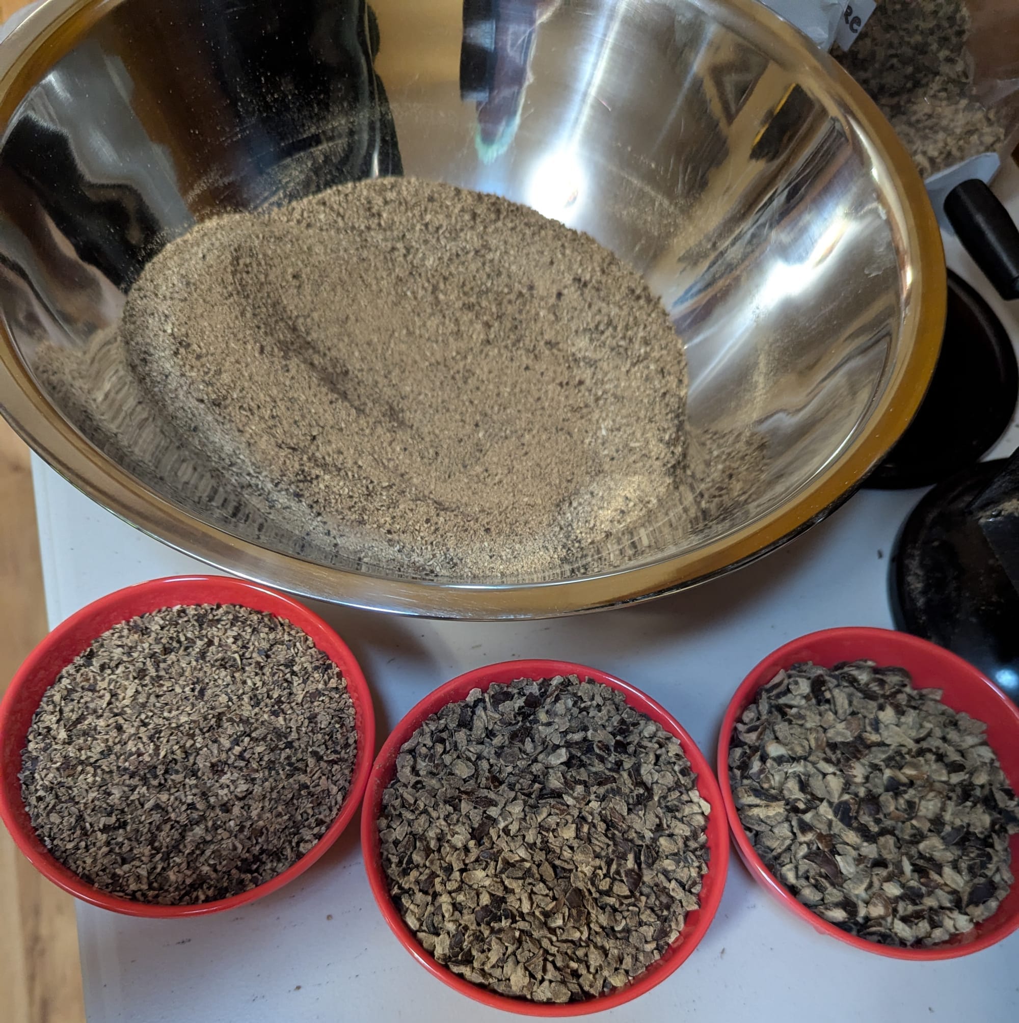 Four bowls of acorn bits of different sizes
