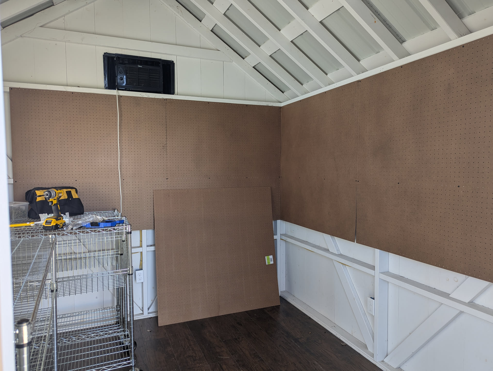 The interior of the Montague Commoners market cabin, showing new pegboard panels that we're putting up to display merchandise