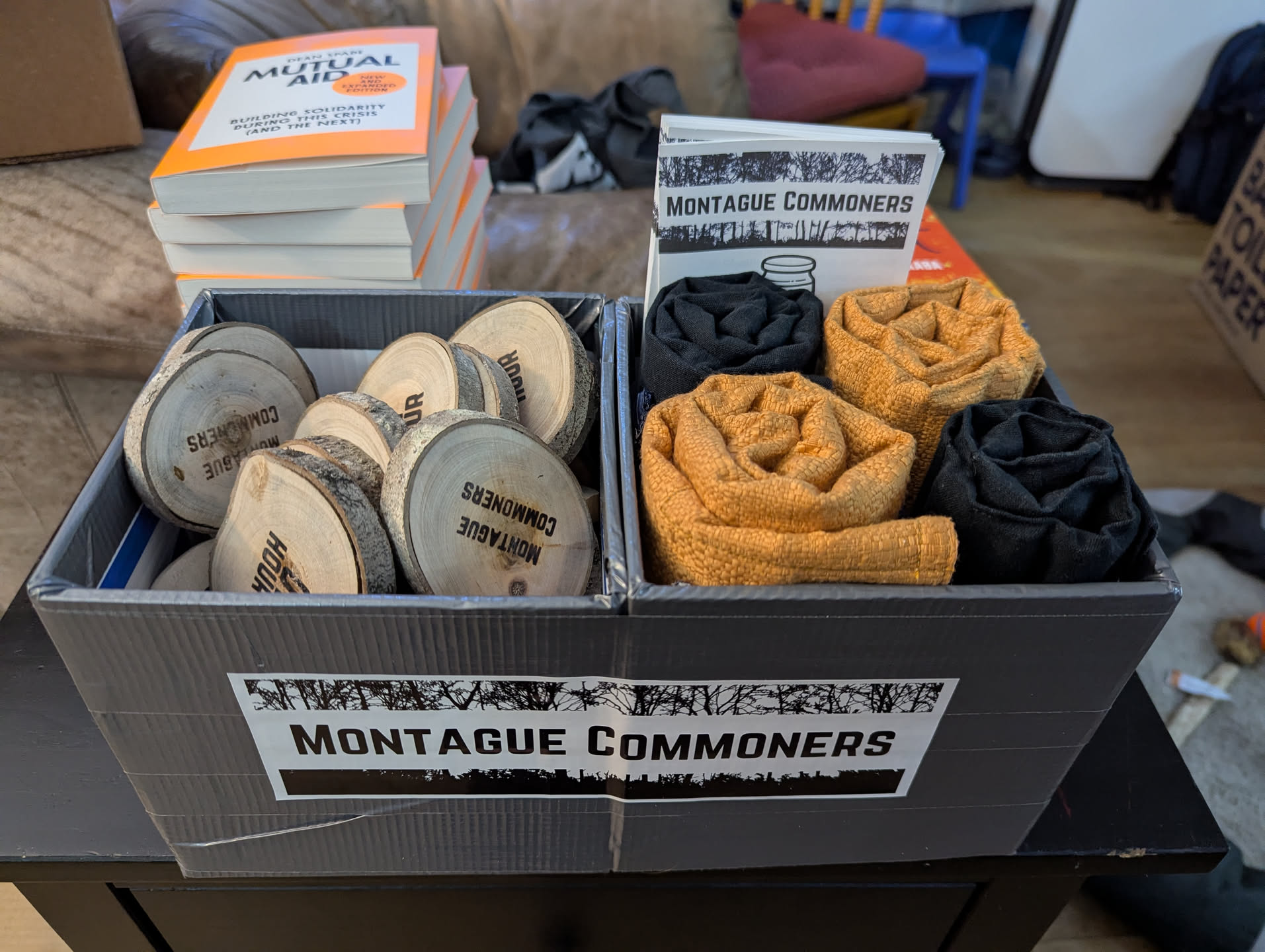 A two-part box with blank wooden hour tokens on one side and rolled-up marker kits on the other