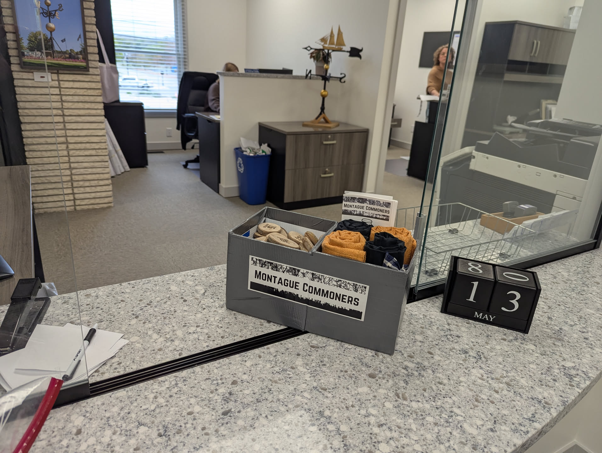 A token painting station made out of yard signs and duct tape sits on the window-desk at the entrance to City Hall