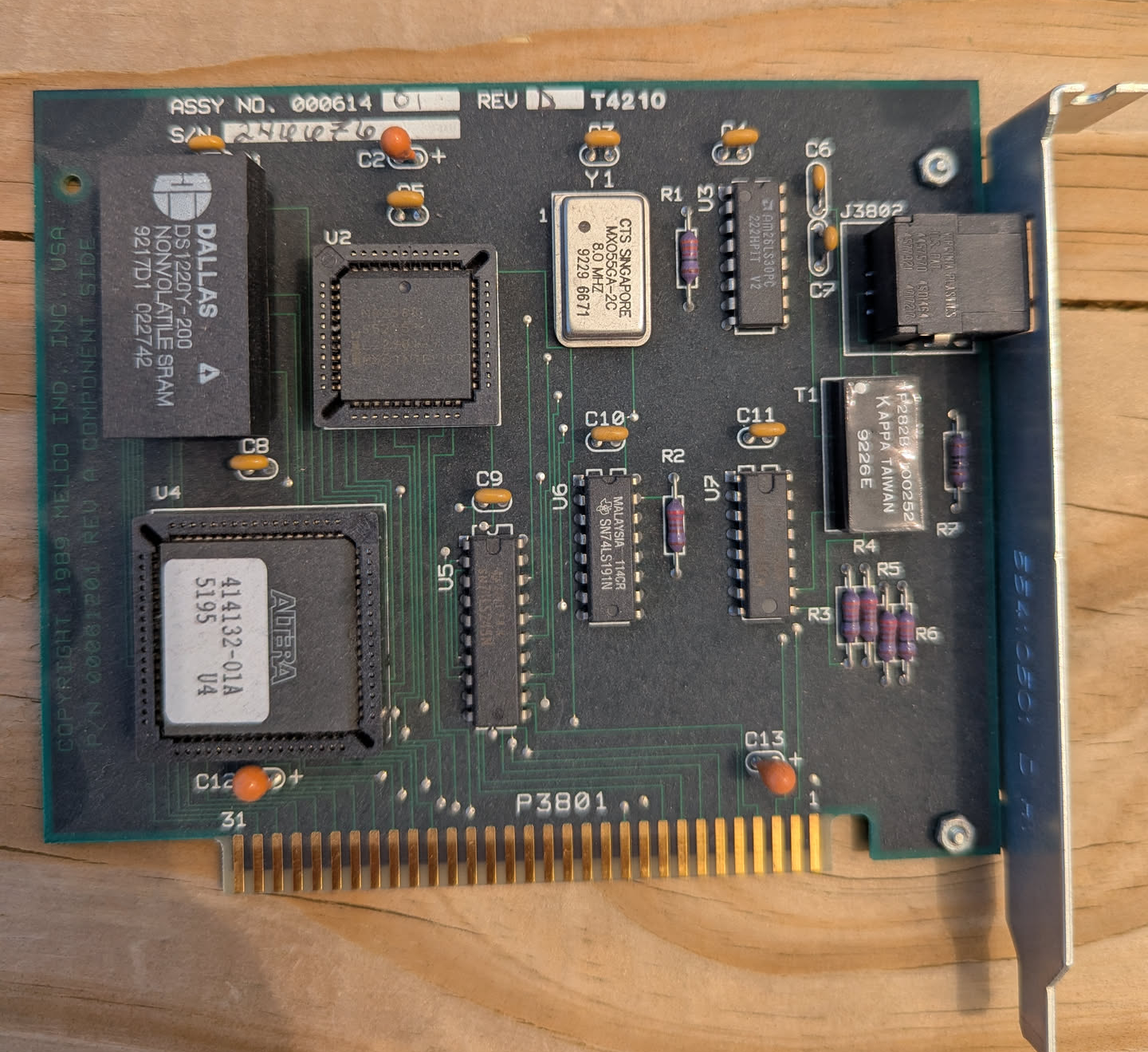 A very old expansion card with a handwritten serial number on it