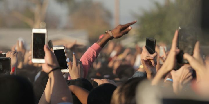 crowd holding up phones
