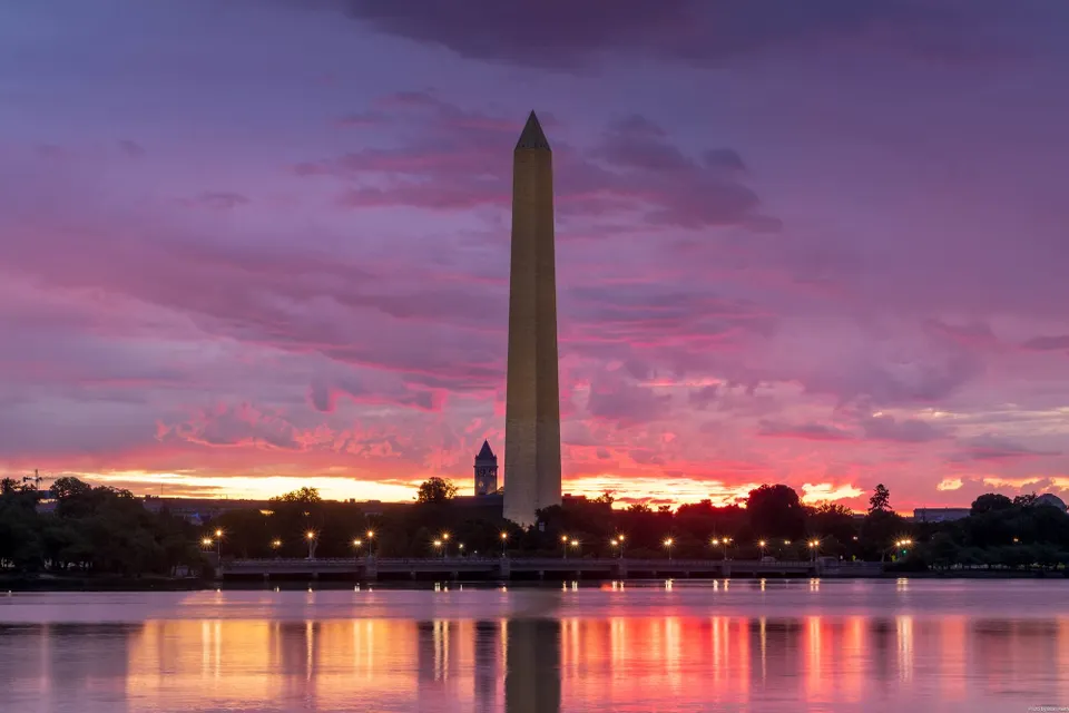 Photo of a colorful and cloudy dawn sky at the Tidal Basin on Sunday.