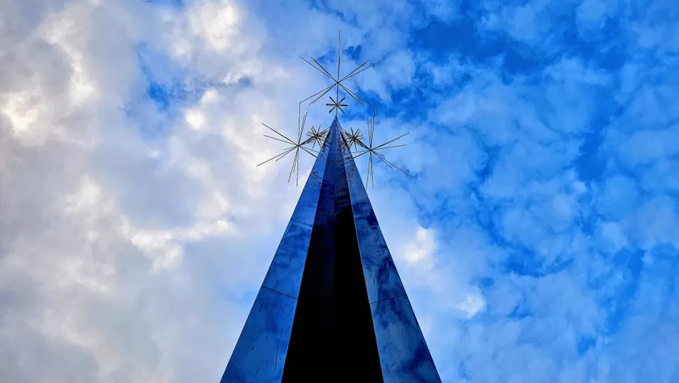 Clouds, filtered sun, and a bit of blue sky above the Ad Astra sculpture.