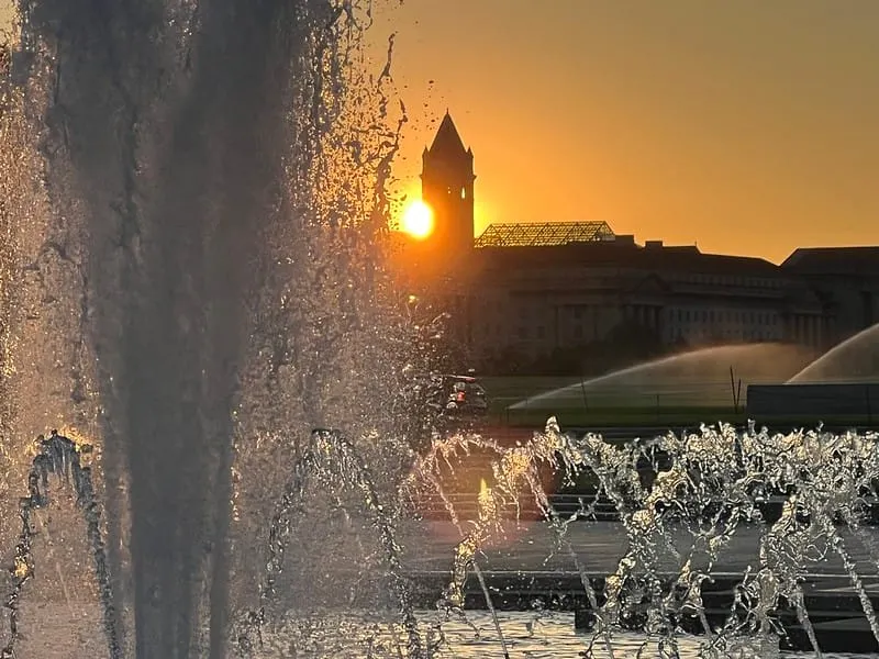 An orange sunrise behind the Old Post Office on Monday.