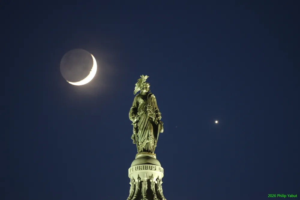 Photo of the moon and Venus flanking the Capitol's Statue of Freedom.