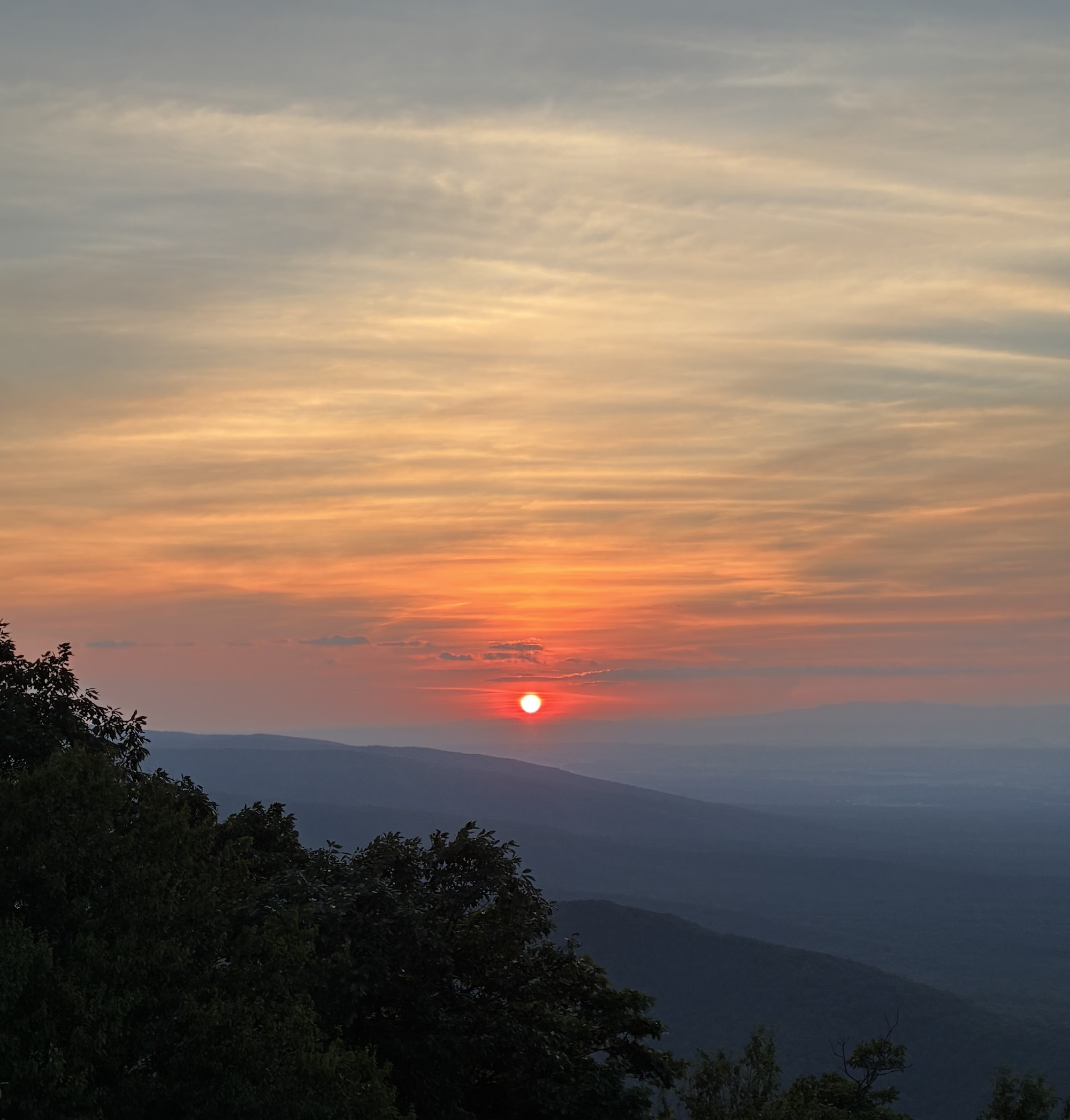 Photo of a smoky sunset from the Ravens Roost overlook on the Blue Ridge Parkway