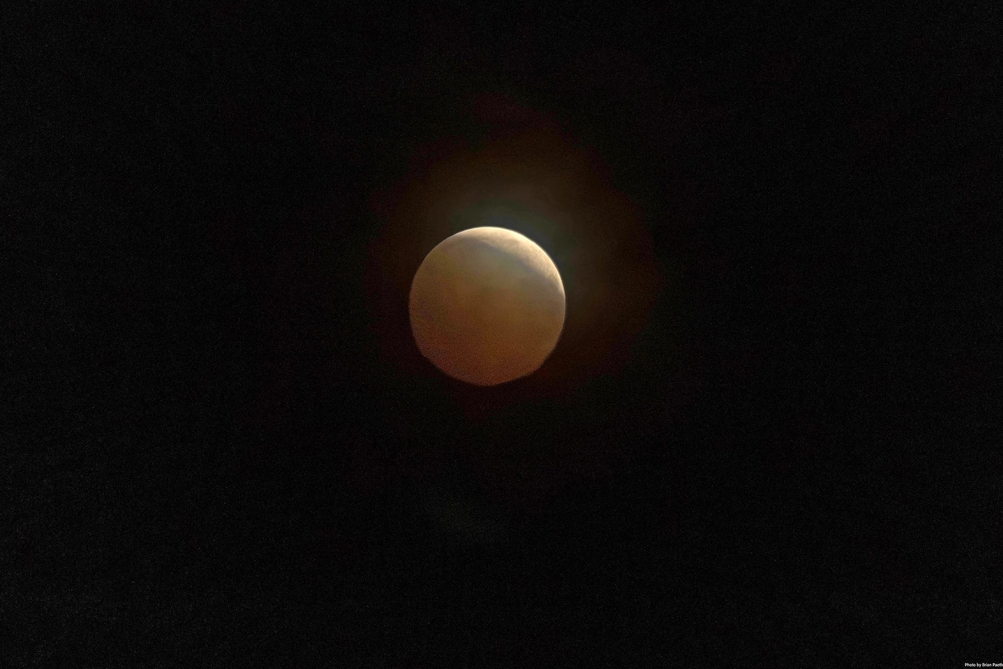 Lunar eclipse and a cloudy sky viewed from Burke, Virginia, at 11:50 p.m. Thursday.