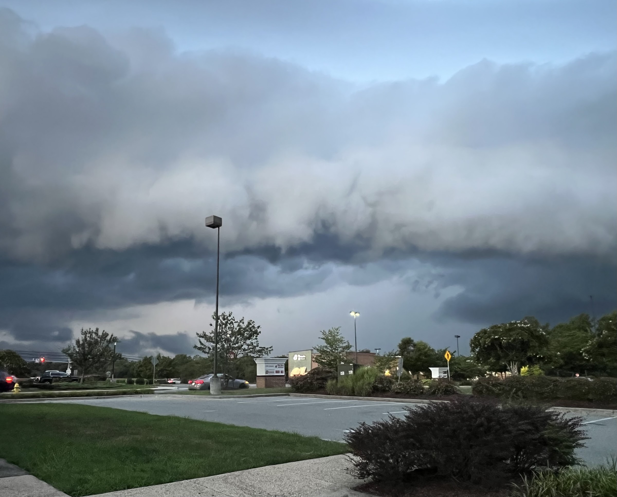 Storm clouds approach La Plata as seen from a parking lot. There is a shelf cloud streched from left to right.