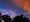 Colorful skies with trees in foreground
