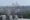 The Washington National Cathedral is seen from Kalorama with a rooftop in the foreground and buildings in between. 