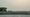 A smoke-filled view of DC from Arlington. The sun is dim, the sky is gray and the monument is hard to see.
