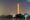 A smokey haze around the Washington Monument with the Tidal Basin in the foreground. 