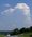 A tall cumulonimbus capped with pileus cloud since it was building so quickly along route 17 it reached icy portions of the atmosphere