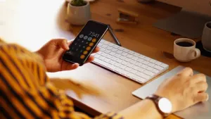 This is a picture of a woman using a calculator.