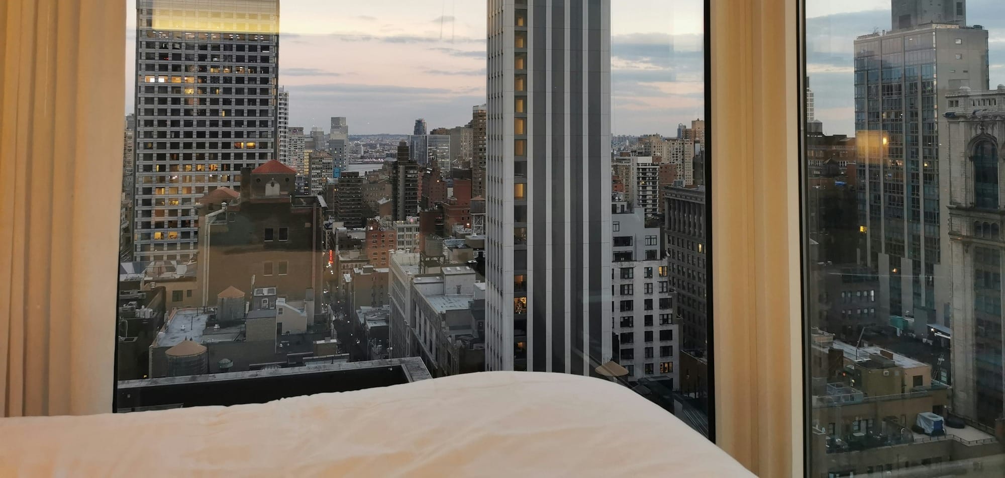 a bedroom with a view of the city