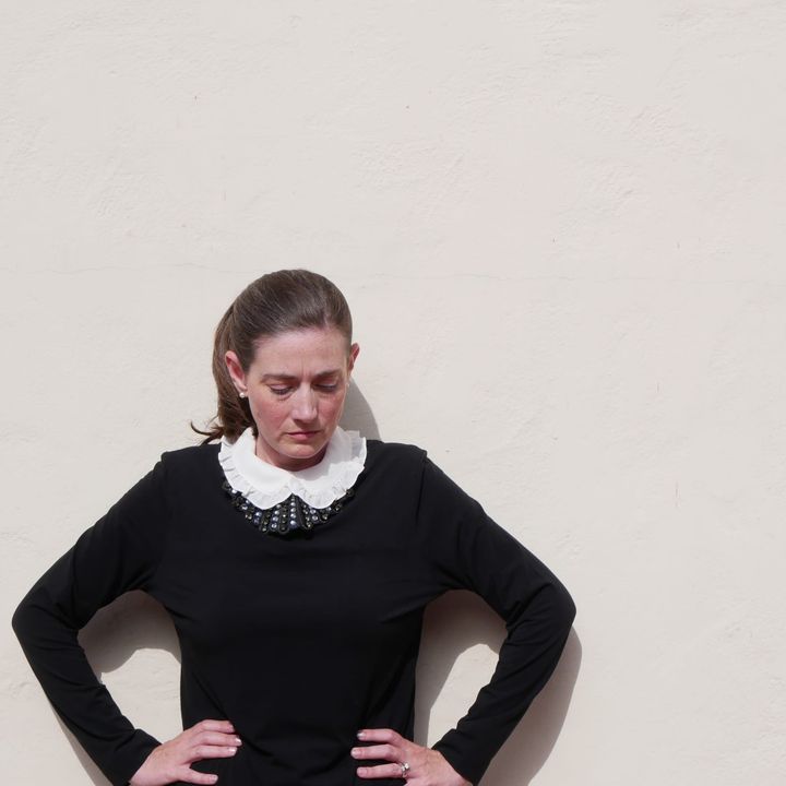 Photo of Jill Fields wearing a dissent collar in the style of Justice Ruth Bader Ginsberg, cast against a stark, white background.