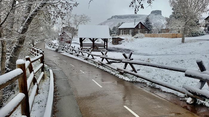 The bike and pedestrian path on the south side of Clear Creek. The Clear Creek History Park is covered in snow and Castle Rock appears in the background.