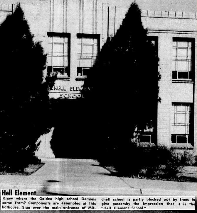 Overgrown evergreens screen many of the letters in MITCHELL ELEMENTARY. What is left spells out HELL ELEMENT.