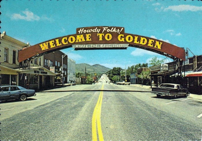 Washington Avenue and the Welcome to Golden arch with only two parked cars in front of the stores