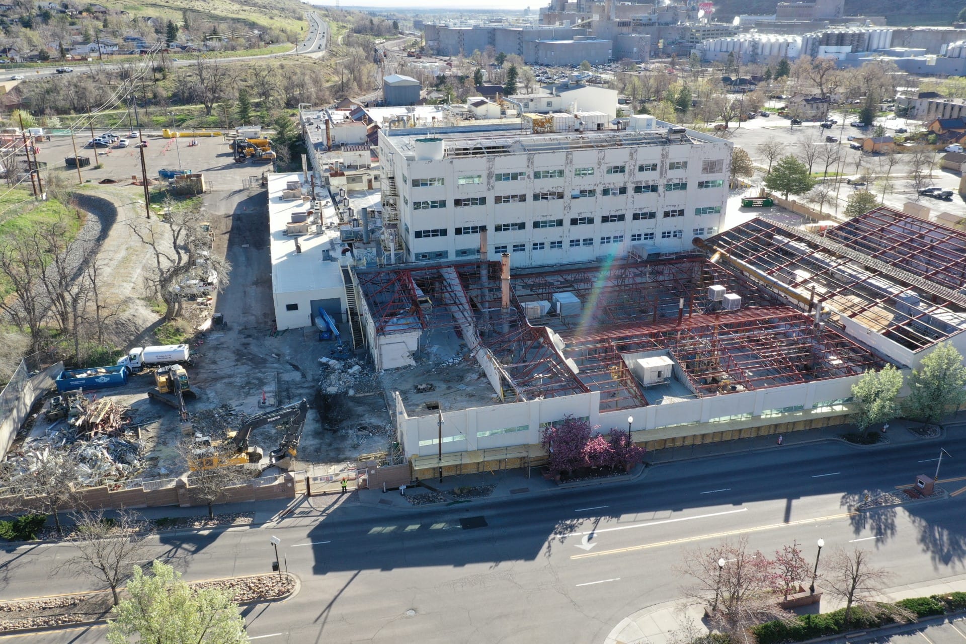 Aerial view of a very large building, roofless except for the steel roof girders