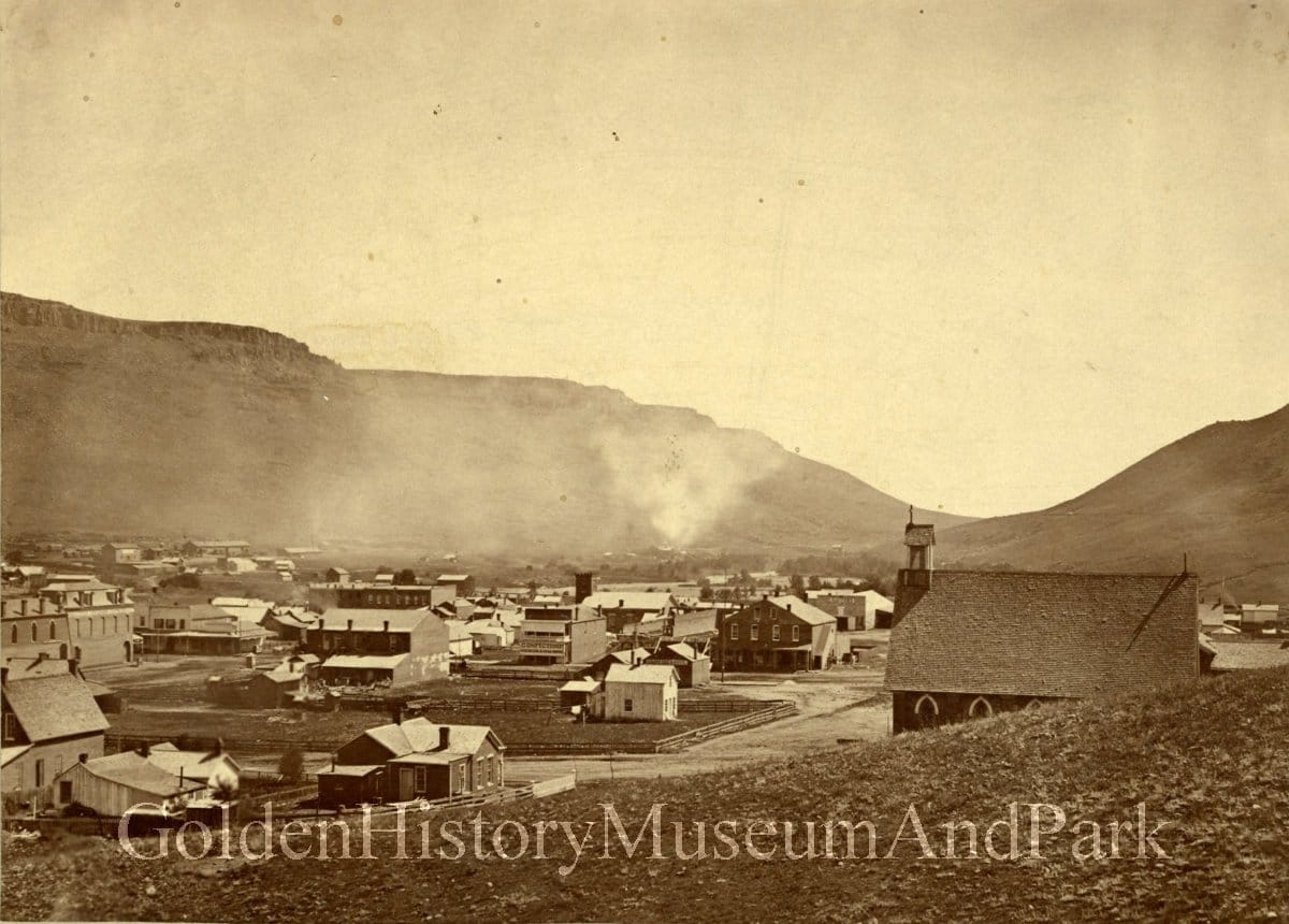 sepia-toned early photo of Golden with Calvary Church and the Loveland block in brick & other buildings of frame