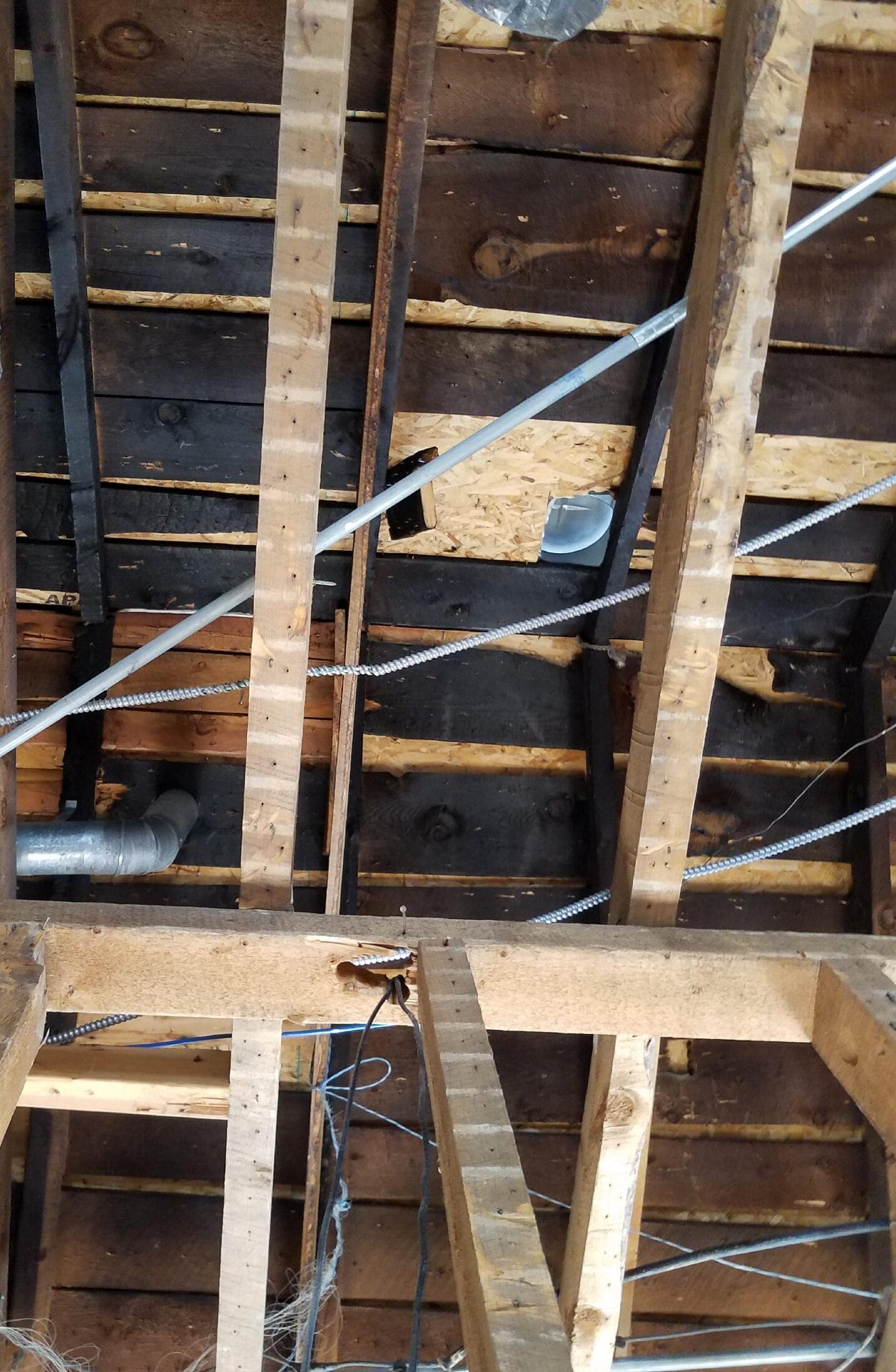 the underside of the roof shows a significant number of blacked and incomplete boards