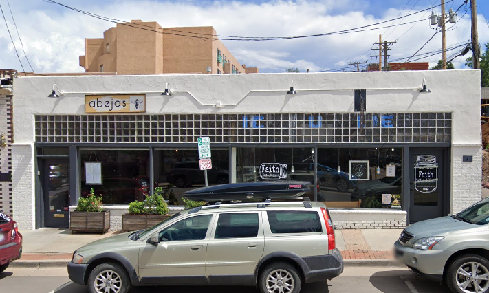 white-painted commercial building with glass blocks over plate glass windows