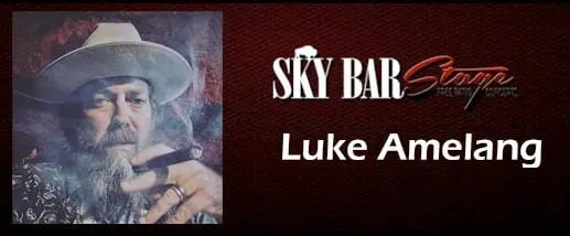 Luke Amelang at the Buffalo Rose - shows man in cowboy hat holding a smoking cigar