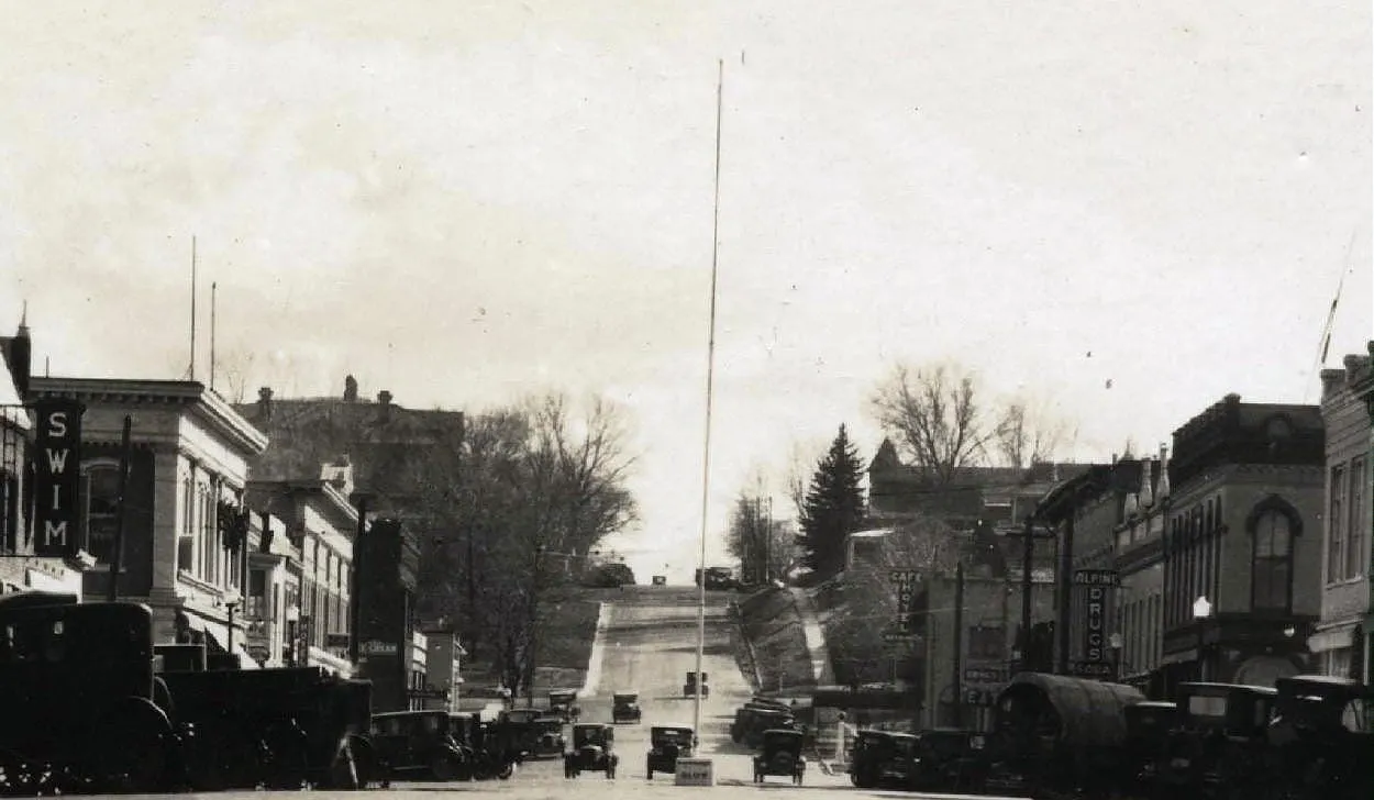 black and white image downtown Golden, looking south from 11th and Washington. Tall pole without flag at 12th & Washington