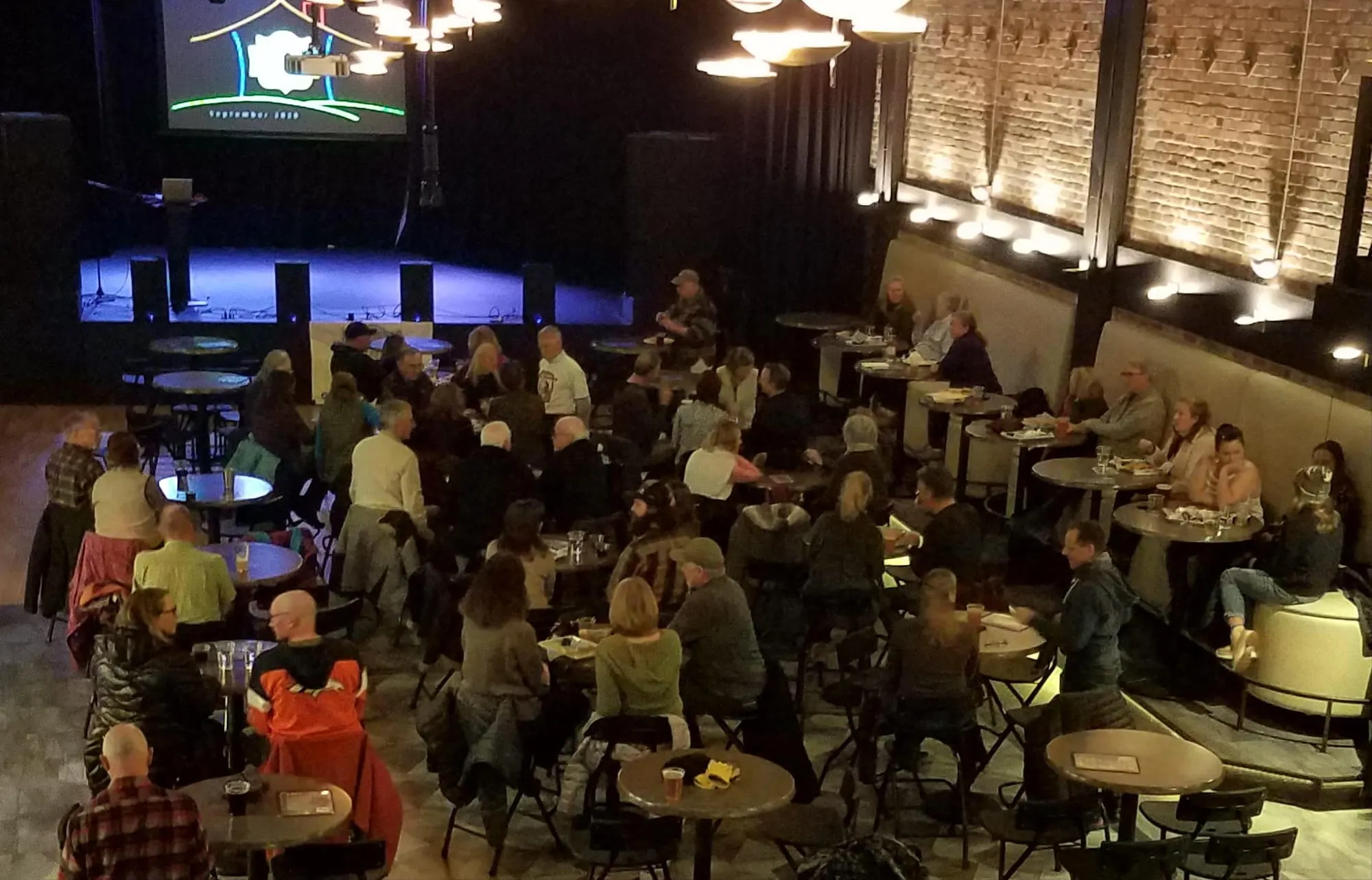 About 35 people sitting at tables waiting for Golden Beer Talks to start