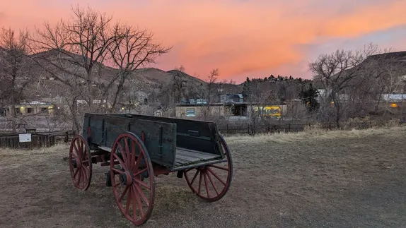 a wagon in a field at dawn