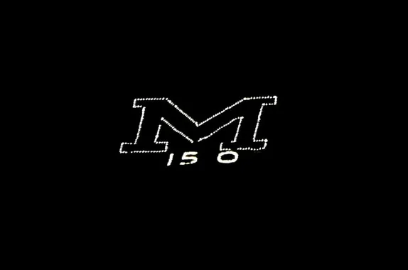 An "M' outlined in white lightbulbs against a black background - "150" written beneath the M.