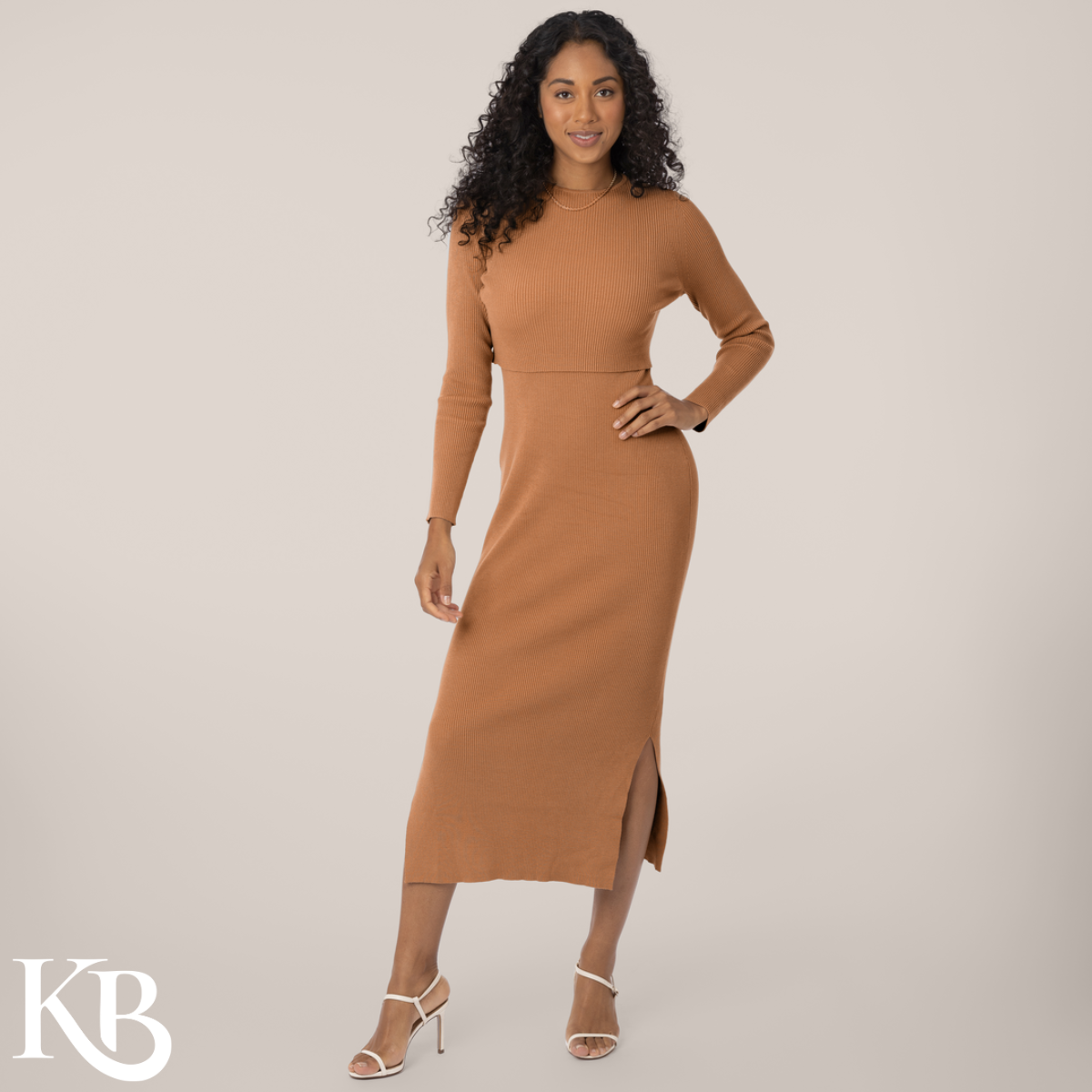 A woman in a camel-colored, layered nursing and maternity maxi dress with long sleeves.