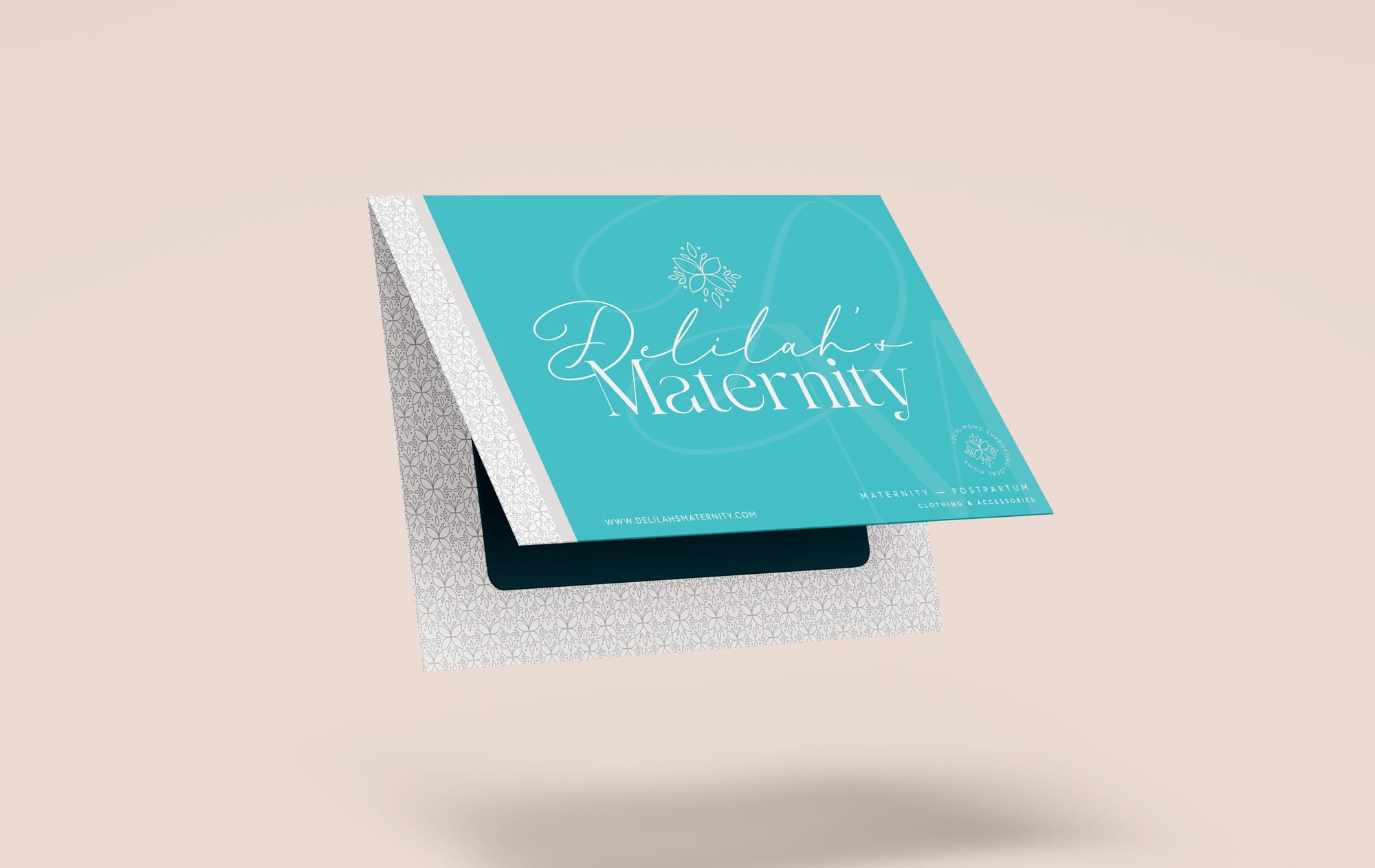 Floating gift card for Delilah's Maternity featuring teal and white branding with floral patterns, ideal for Mother's Day gifting.