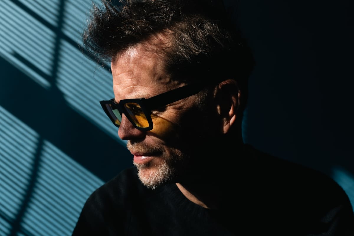 Donny McCaslin portrait, looking down - Photo by Dave Stapleton.