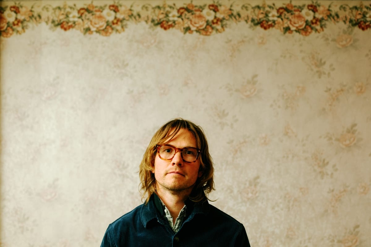 Jens Kuross in front of a wall - Photo by Mark Oliver