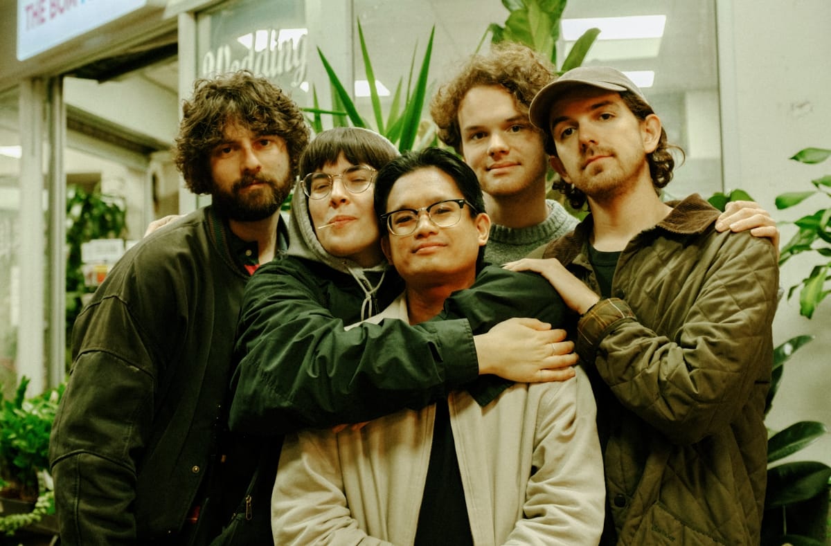 The five members of Living Hour in a group hug - Photo by Devonte Johnson