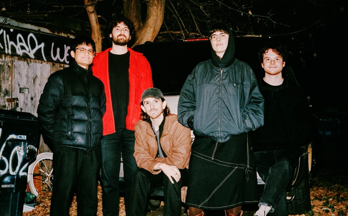 The five members of Living Hour looking cold and wearing jackets - Photo by Matt Horseman