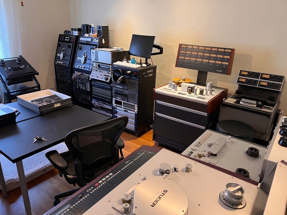 Osiris Studio interior with vintage reel-to-reel machines, equipment racks, mixing gear, and workstations.