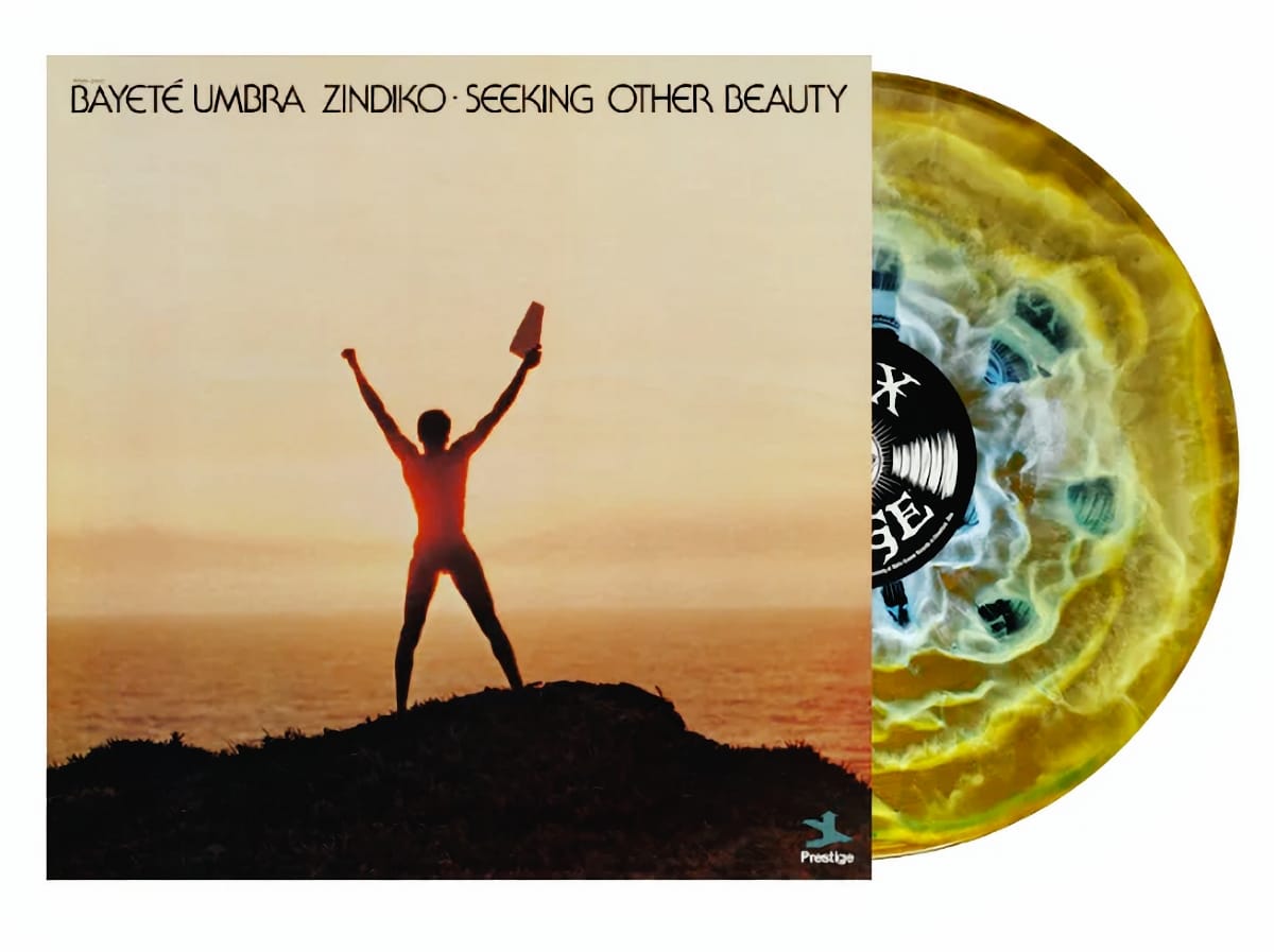 Bayeté Umbra Zindiko album showing silhouette at sunset with arms raised, marbled yellow-blue vinyl beside cover.