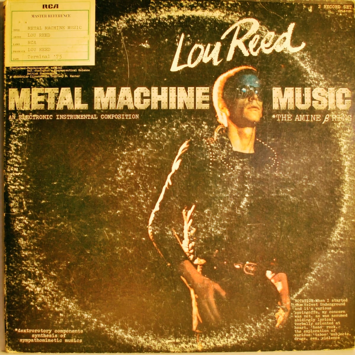 Original worn vinyl sleeve for Lou Reed's Metal Machine Music on RCA, with a amber-tinted stage photo, the album's subtitle "An Electronic Instrumental Composition," and a master reference label affixed to the upper left corner.