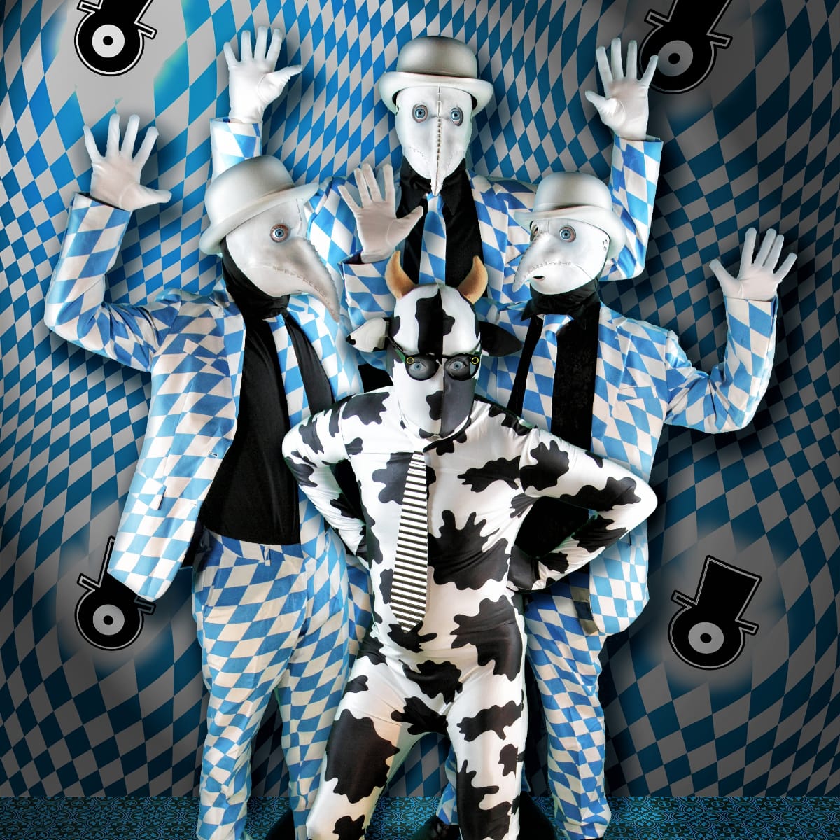 The Residents: three figures in white beaked masks, silver bowlers, and blue-and-white diamond suits raise gloved hands behind a fourth in a horned cow-print bodysuit and dark glasses.