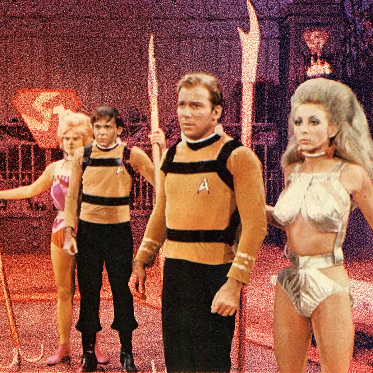 Grainy, red-tinted Star Trek still from “The Gamesters of Triskelion”: Kirk and Chekov in collars and harnesses over gold uniforms, flanked by costumed thralls holding spears.