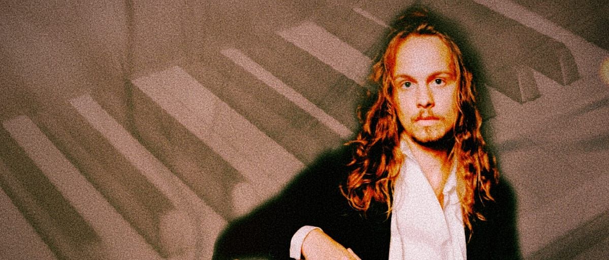 Louis Gardner portrait photo super-impossed in front of piano keys. Photo by Sophia Liv Maguire.