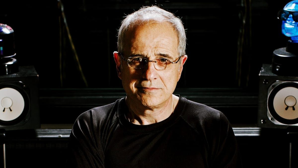 Bob Ezrin faces the camera in a dark studio, lit from the side, with a studio monitor on either side of him.