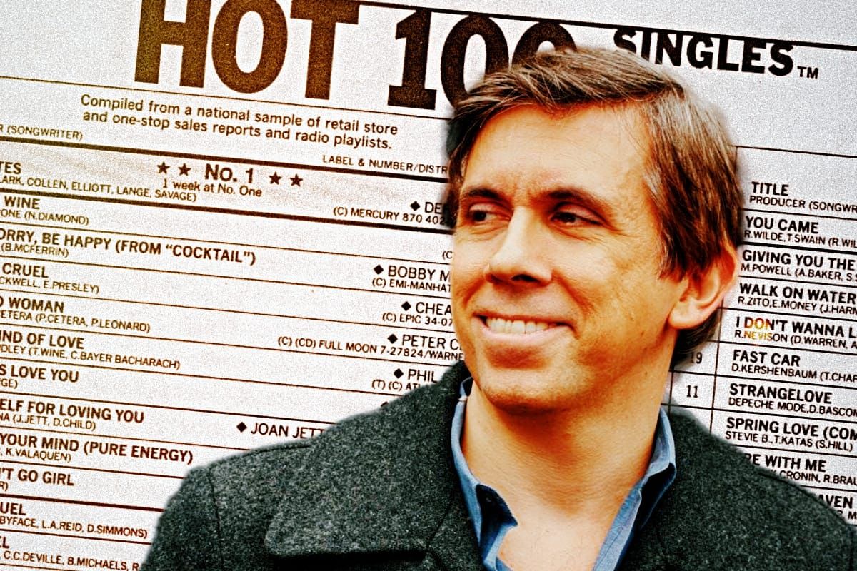 Chris Molanphy smiles in profile against an enlarged 1988 Billboard Hot 100 singles chart, song and songwriter credits legible behind him.