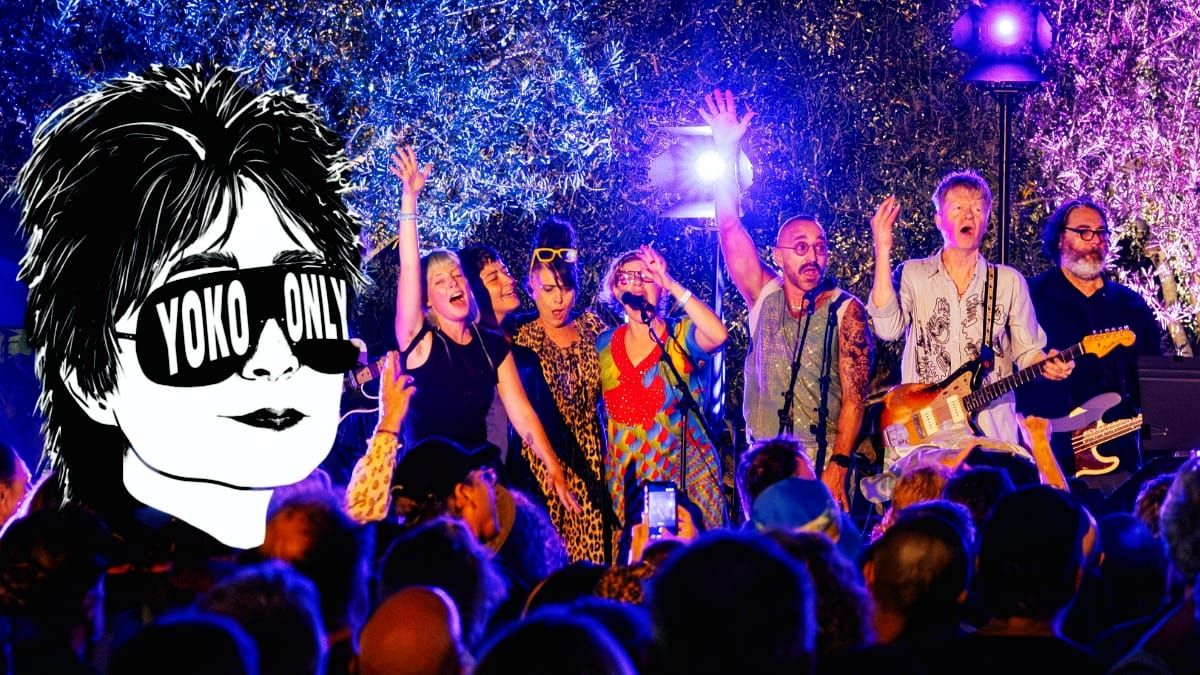Performers sing and play guitar on an outdoor stage lit blue and violet, crowd silhouetted in front; an illustrated Yoko Ono in sunglasses reading "YOKO ONLY" is overlaid at left.