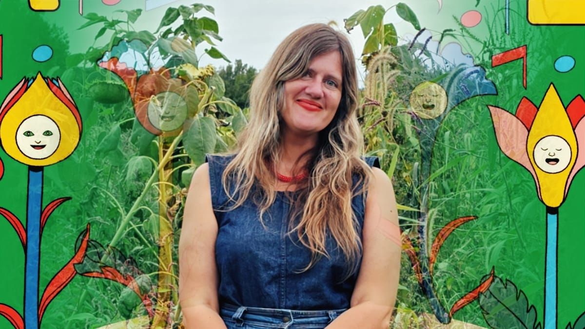 Mary Lattimore smiles in a sleeveless denim top among tall sunflowers and grasses, framed by illustrated cartoon flowers with smiling faces on a bright green background.